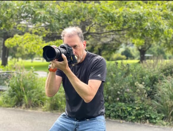 Photographer framing a shot outdoors