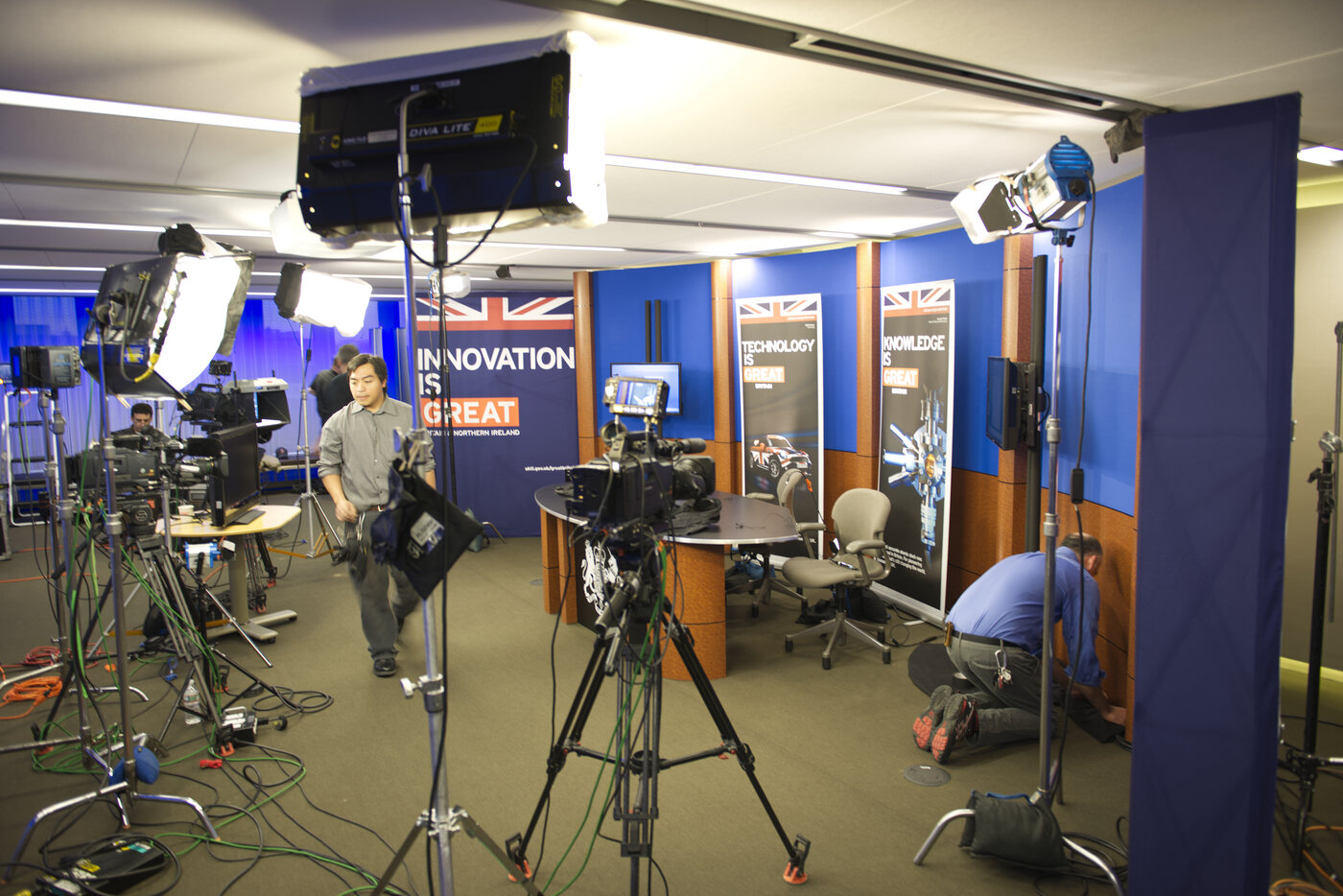 Broadcast studio setup with lighting and camera crew