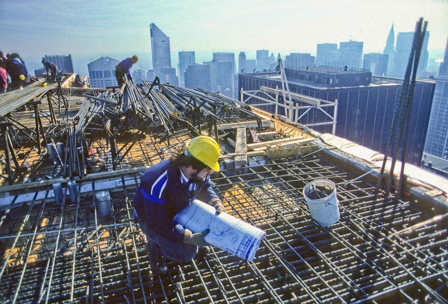 Construction crew on a high-rise site, New York City skyline in the background