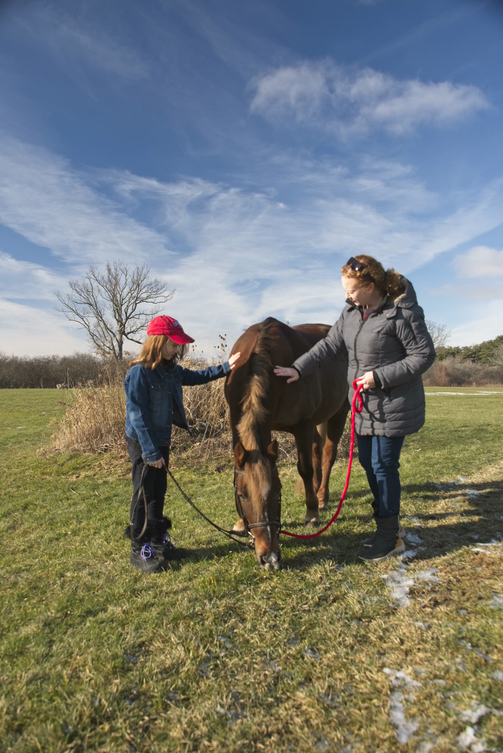 Maeve and her mother with a Cornell Equestrian team horse