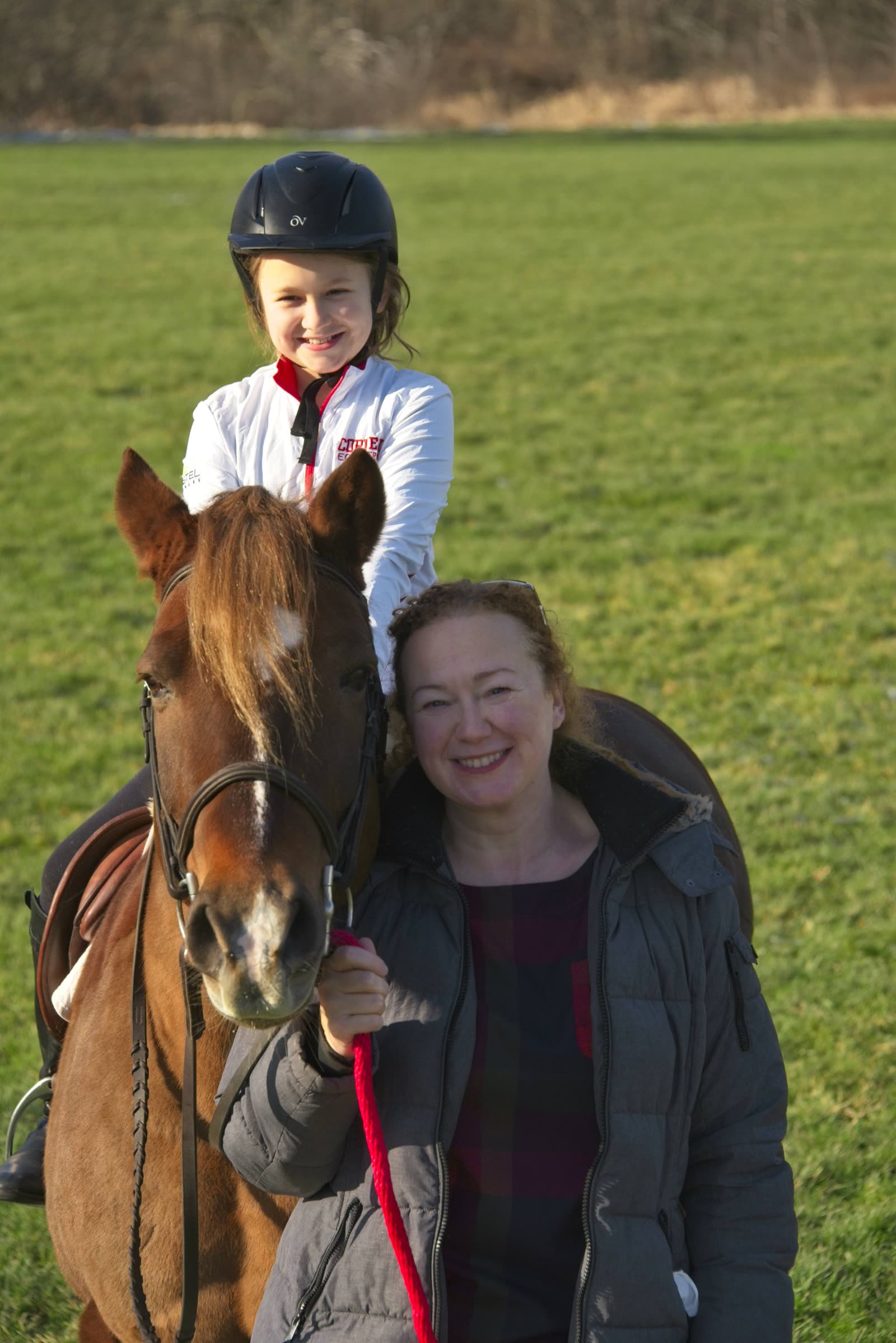 Maeve, riding Moose, with her mother Marisa